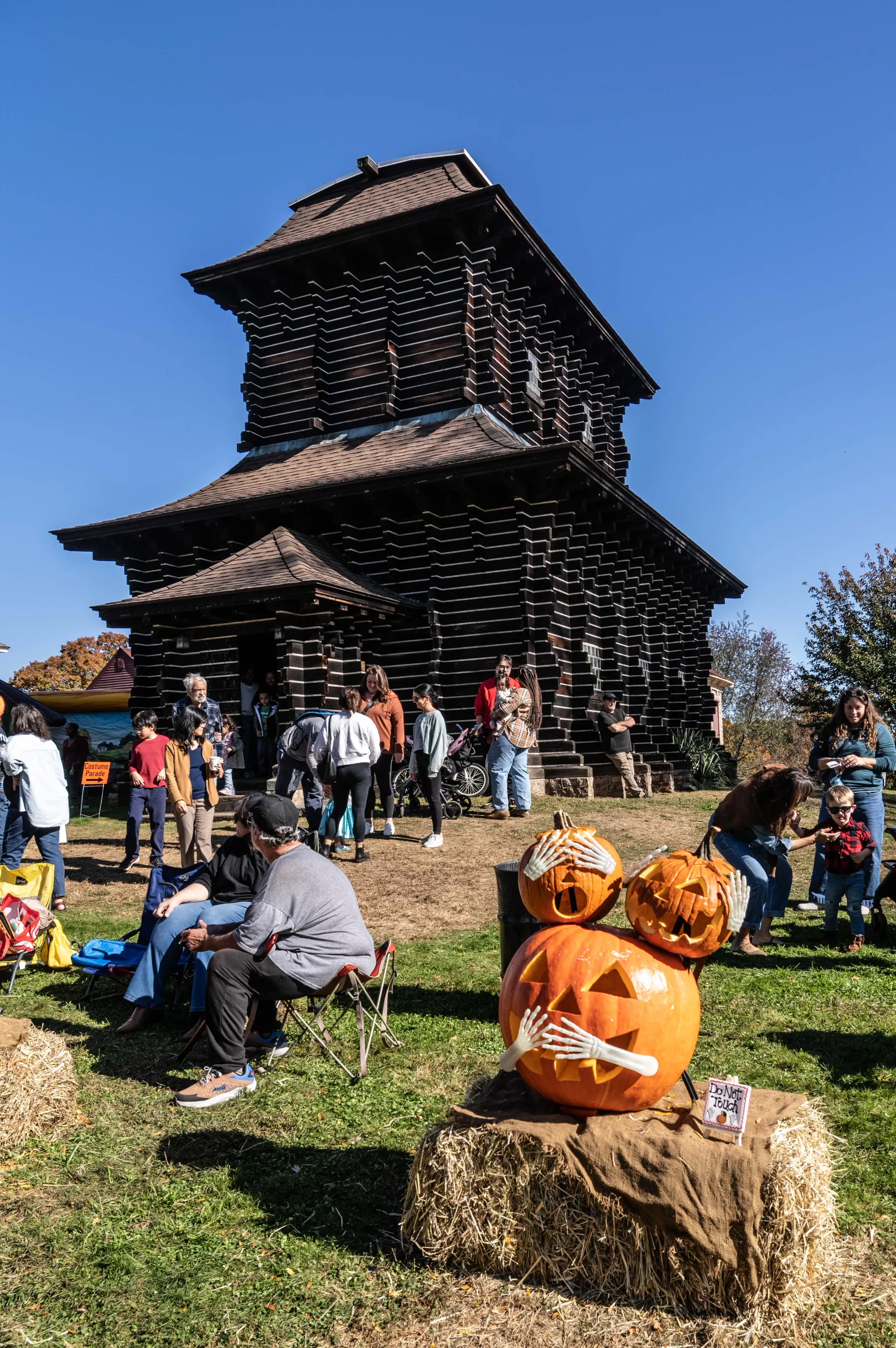 Pumpkin display near a historic Boothe Park building during the Great Pumpkin Festival