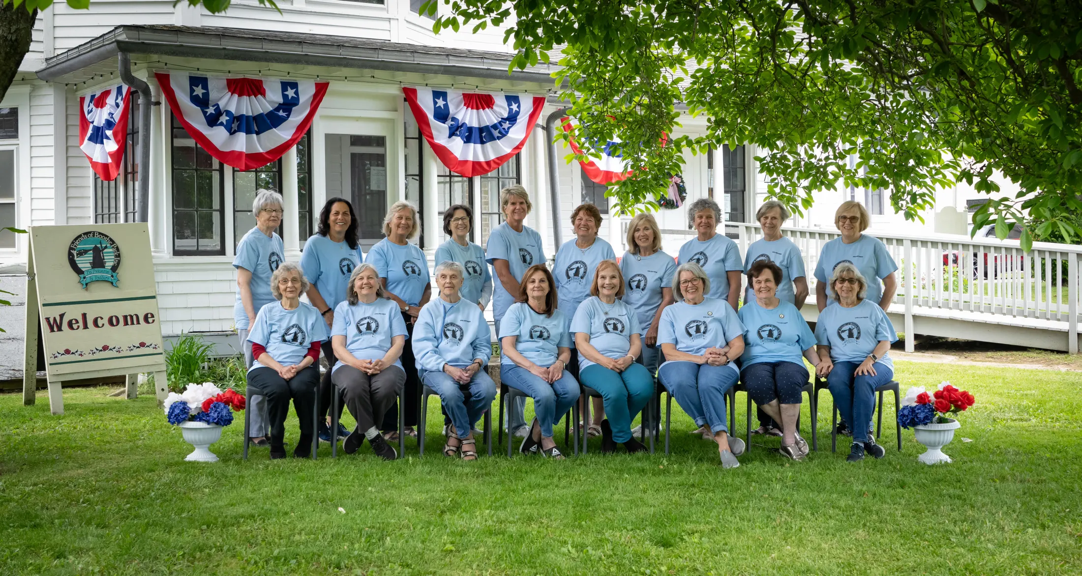 Friends of Boothe Park volunteers gathered outside a historic park building
