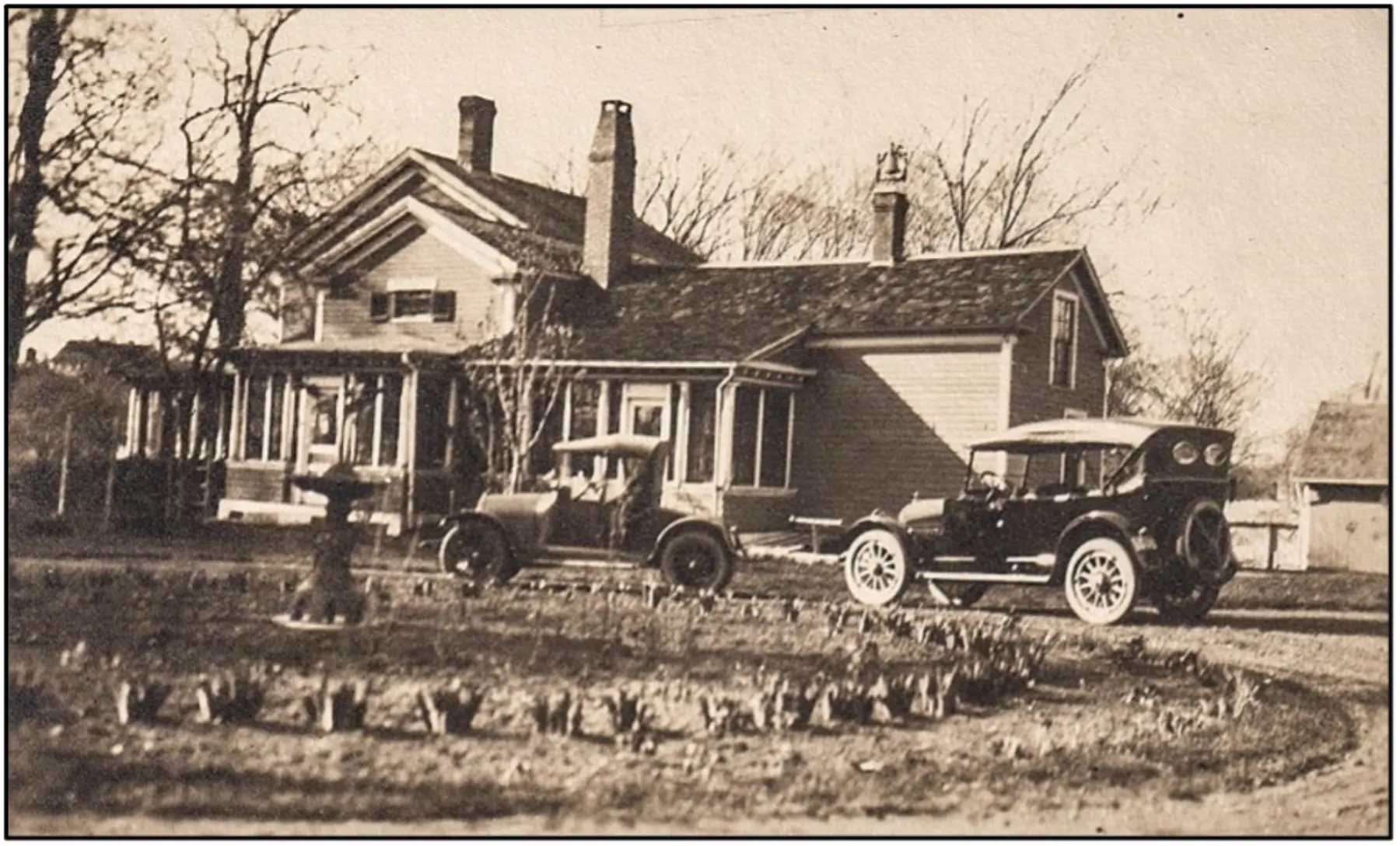 Historic photograph of Boothe Park buildings and early automobiles