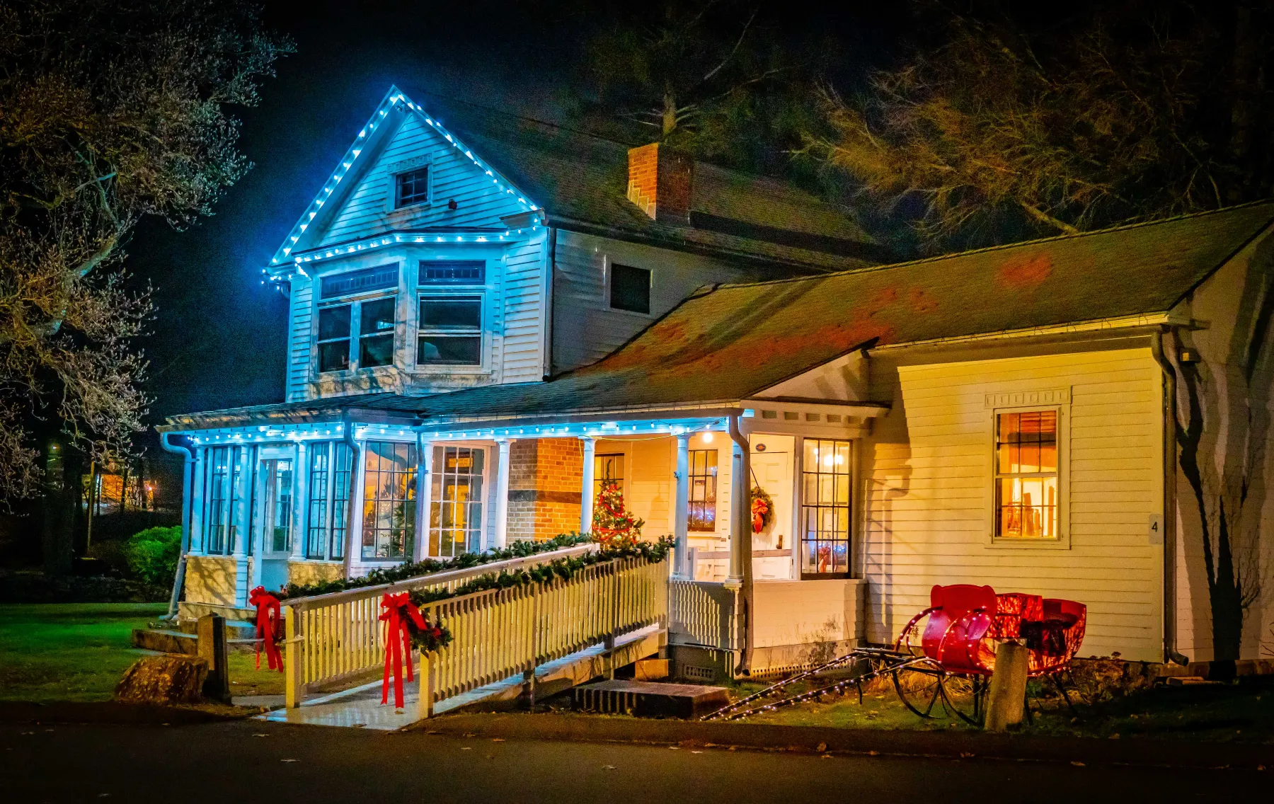 The Boothe Homestead decorated with holiday lights at night