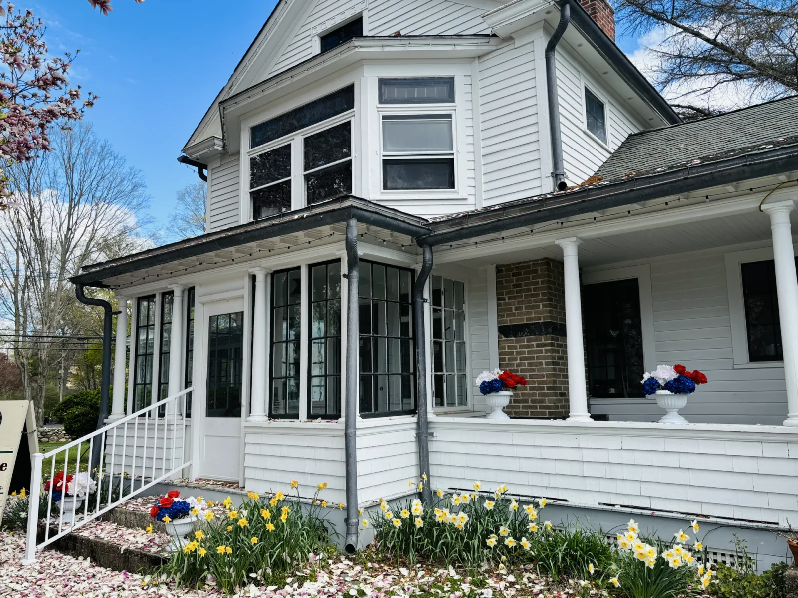Sunlit porch and bay windows of the Boothe Homestead