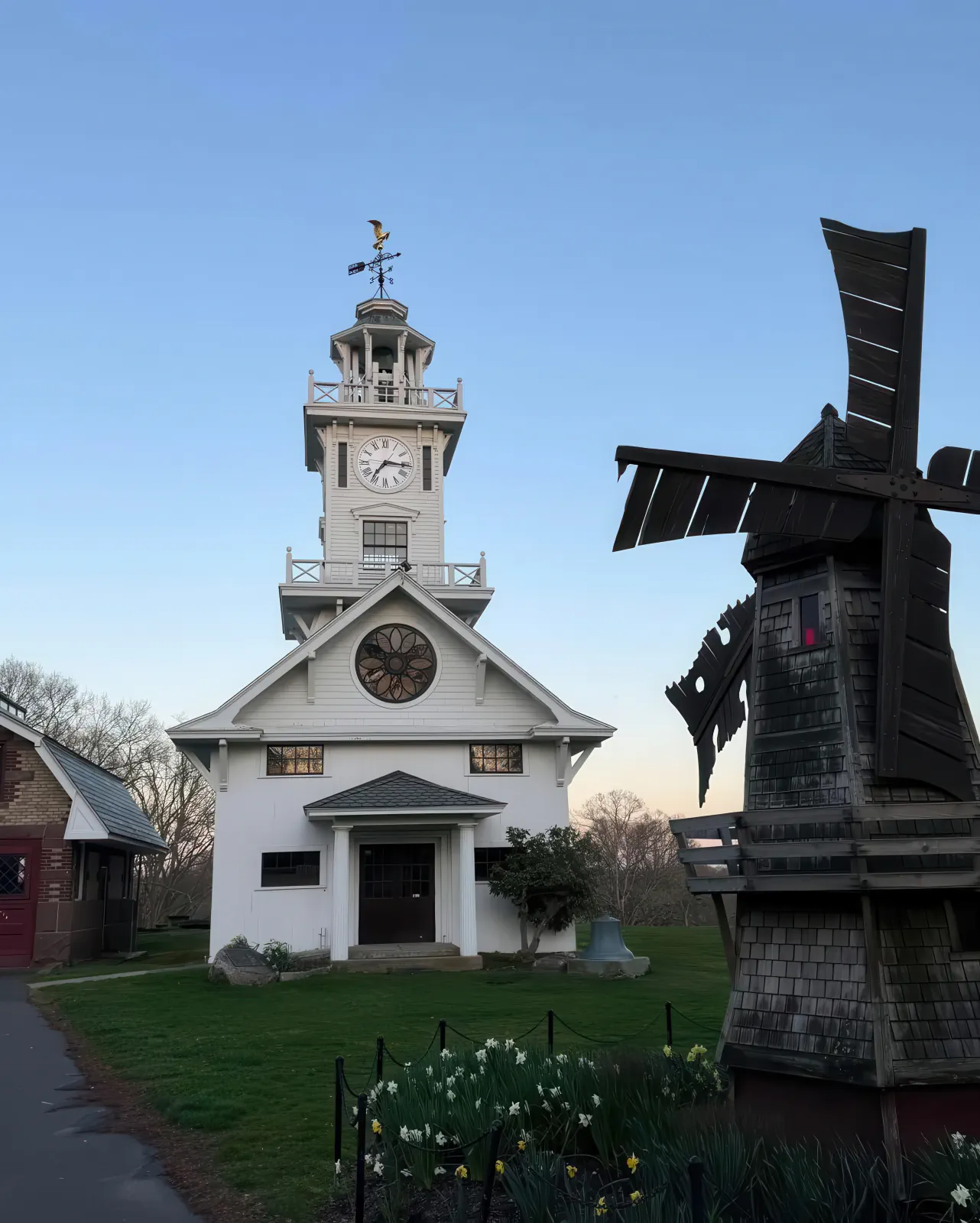 Clocktower Museum and miniature windmill at dusk