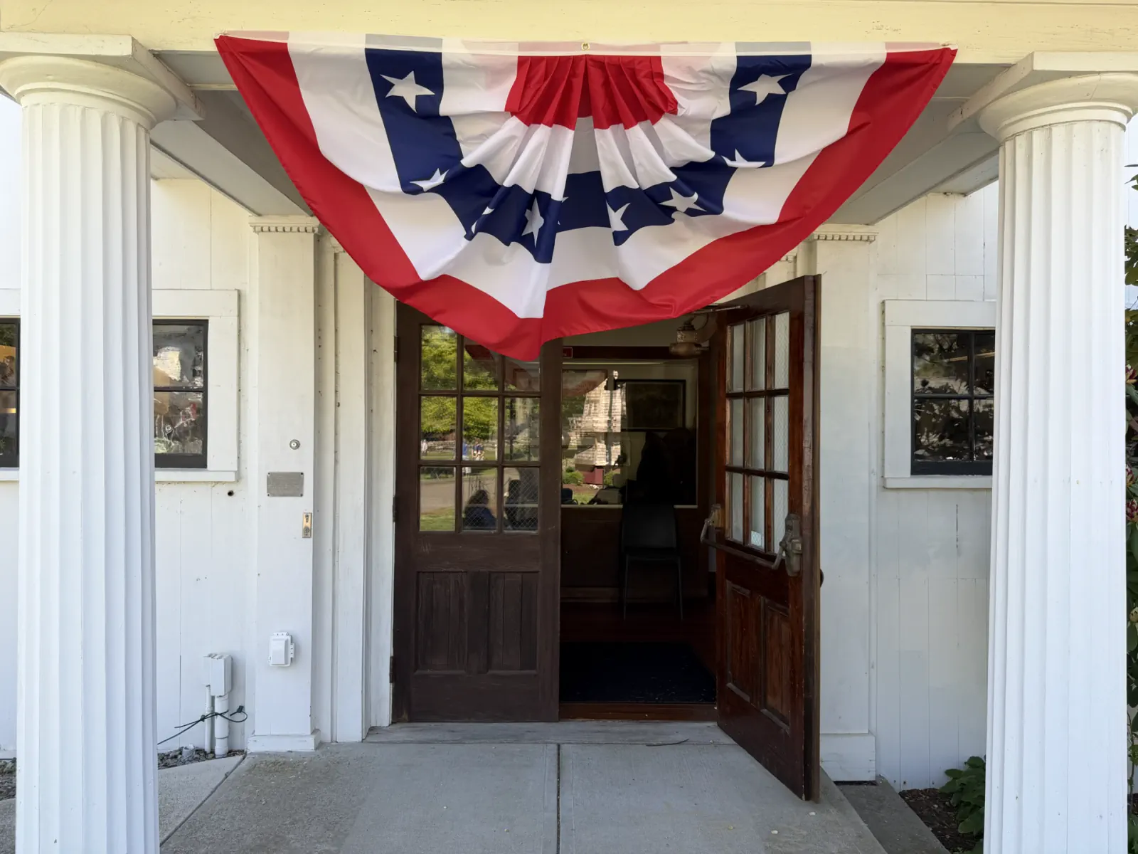Open entrance to the Clocktower Museum decorated with patriotic bunting