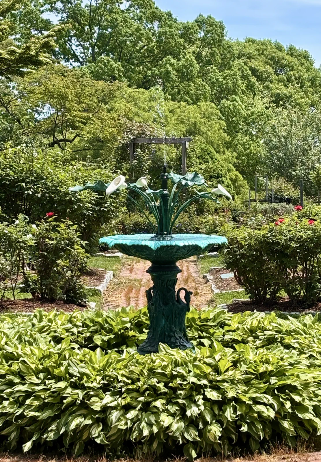 Restored cast iron fountain surrounded by plantings in the Rose Garden
