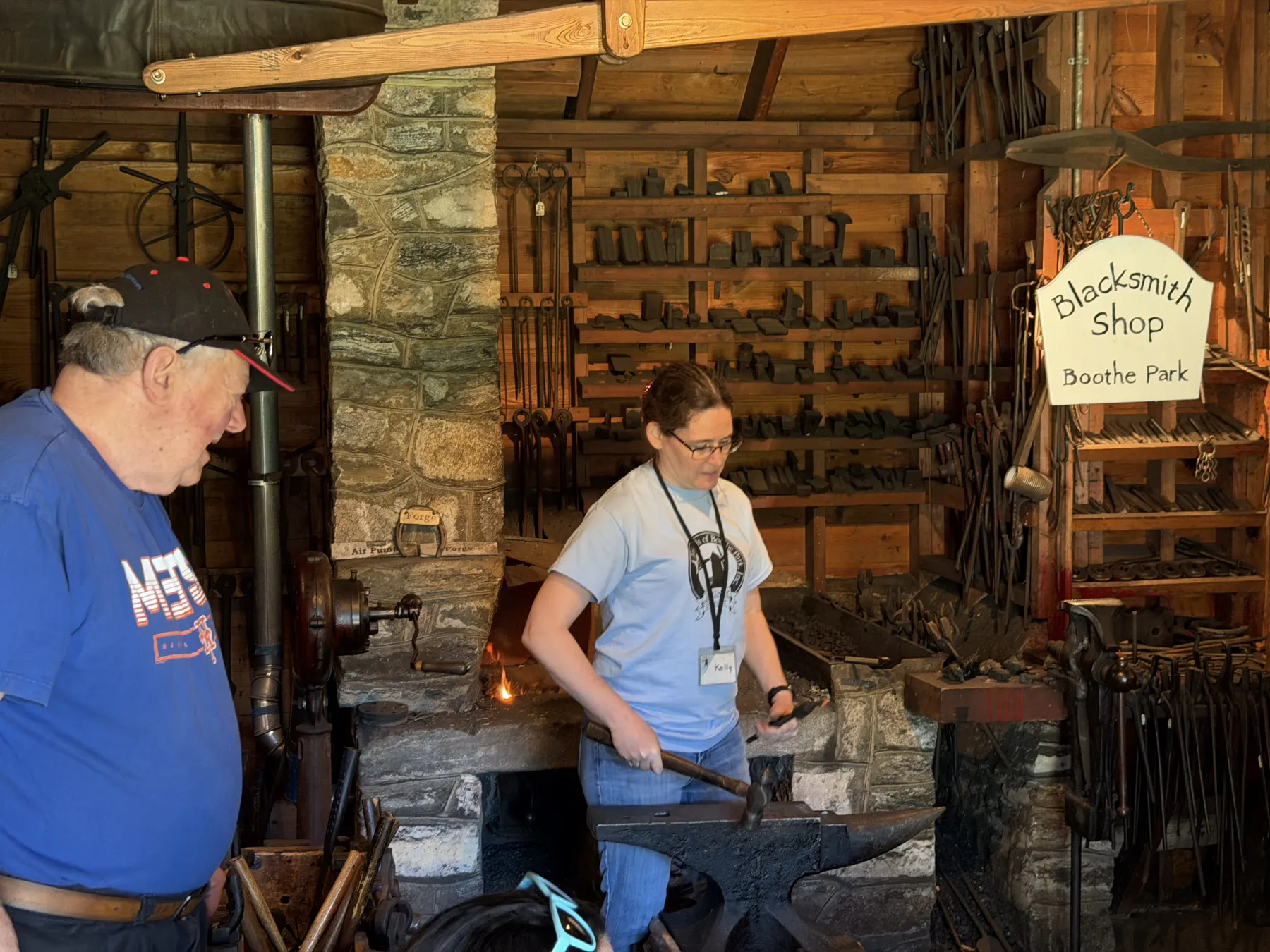 A Boothe Park volunteer demonstrating blacksmithing in the park blacksmith shop