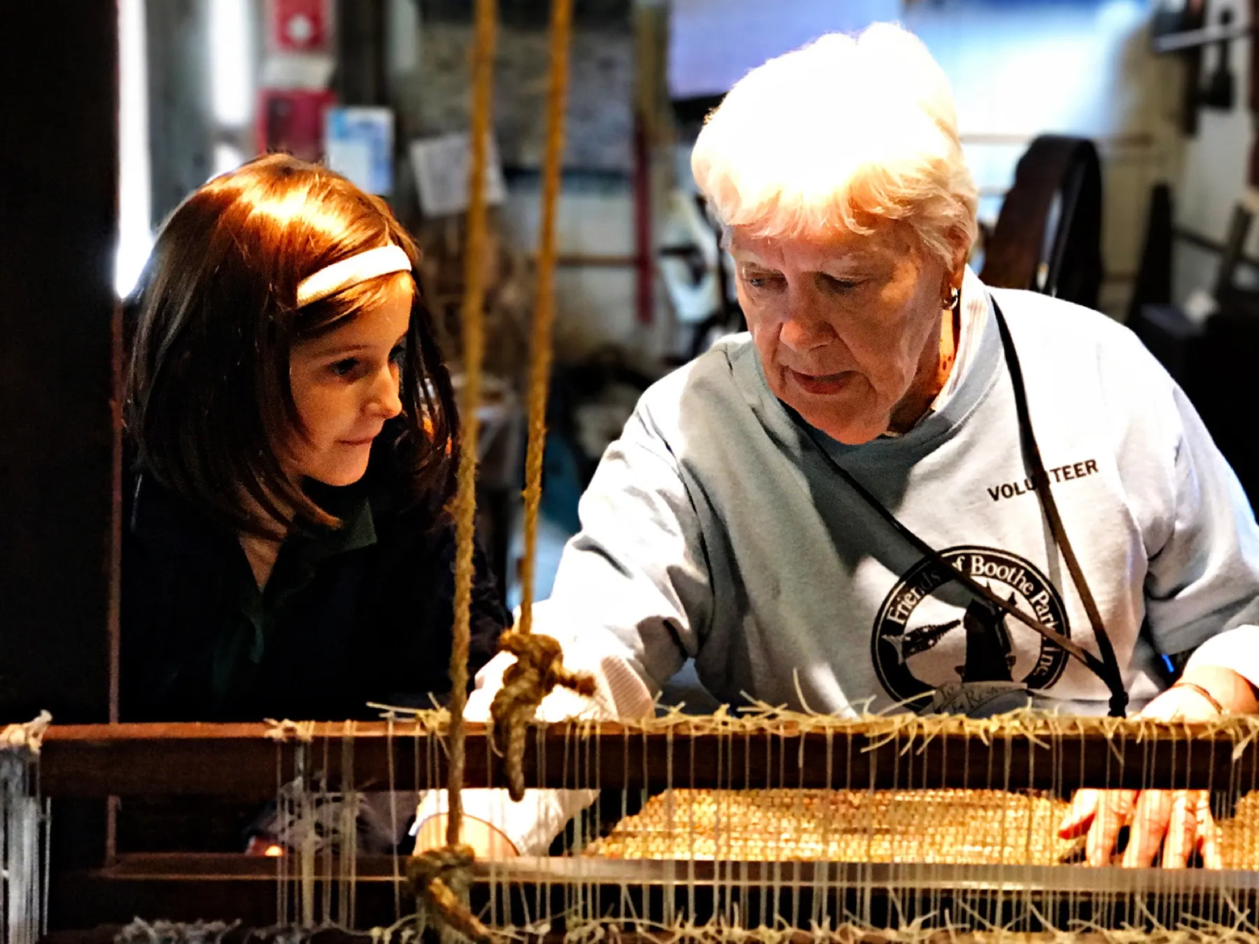 A Friends volunteer sharing a museum exhibit with visitors